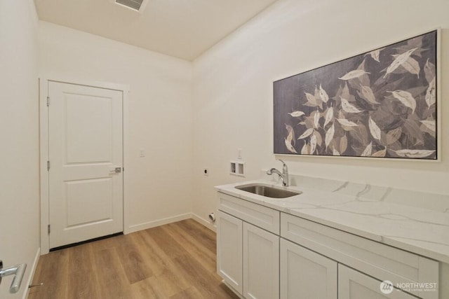 16106 Broadway Ave, Snohomish, WA 98296 - laundry room featuring hookup for an electric dryer, hookup for a washing machine, light wood-style flooring, cabinet space, and baseboards