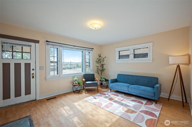 104 Buchanan, Wenatchee, WA 98801 - living area with wood finished floors, visible vents, and baseboards