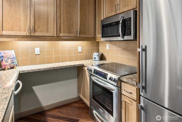 3600 Suncadia Trl Unit 4018, Cle Elum, WA 98922 - kitchen with dark wood-style floors, tasteful backsplash, light stone countertops, and appliances with stainless steel finishes