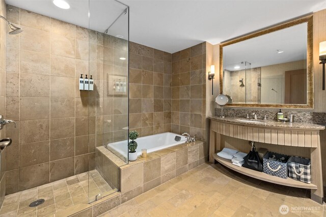 3600 Suncadia Trl Unit 4018, Cle Elum, WA 98922 - bathroom featuring recessed lighting, tile walls, tiled shower, vanity, and a garden tub