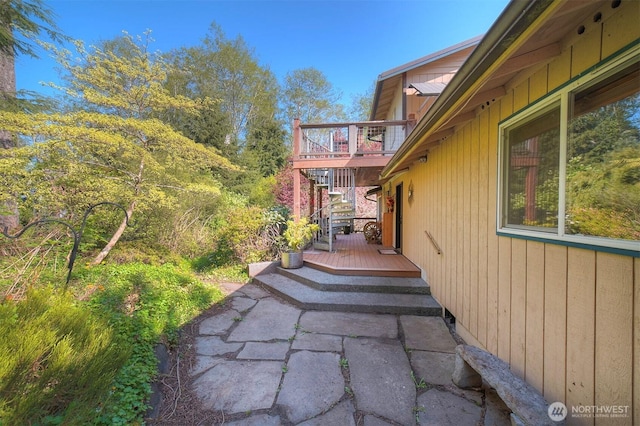 exterior space with a wooden deck and stairs