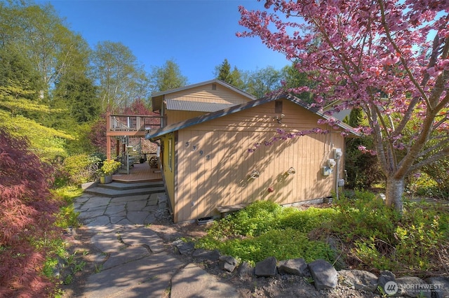 view of side of property with a wooden deck