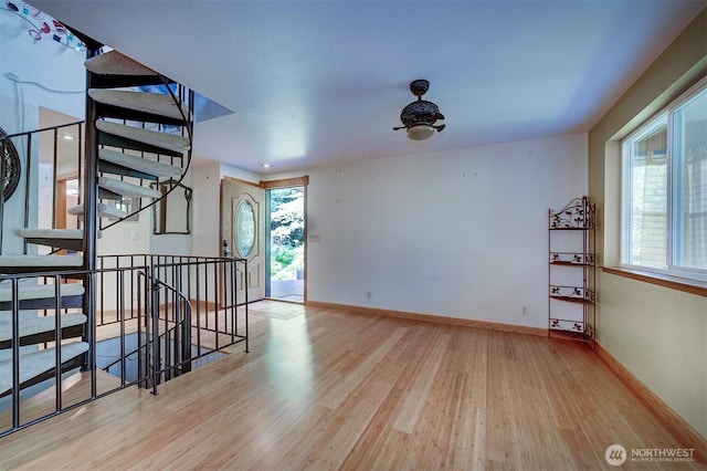 spare room featuring wood finished floors and baseboards