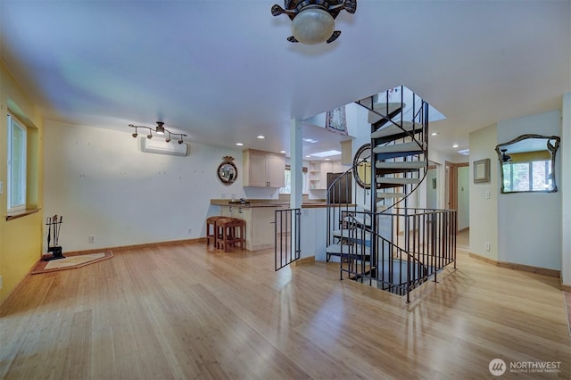 interior space featuring stairway, baseboards, light wood-style floors, and recessed lighting
