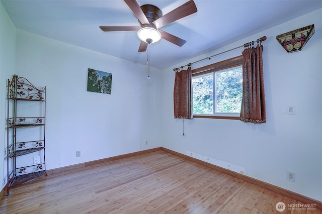 unfurnished room with baseboards, a ceiling fan, and light wood finished floors