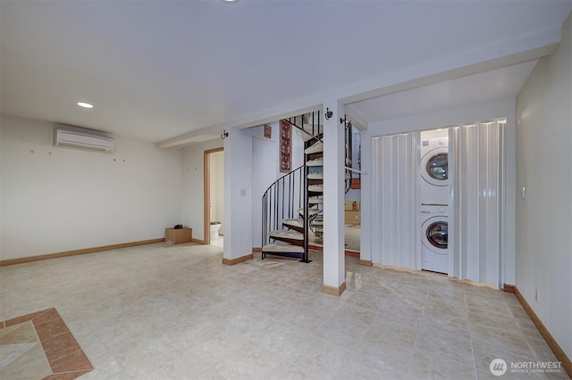 finished basement featuring stairway, stacked washing maching and dryer, a wall mounted AC, baseboards, and recessed lighting