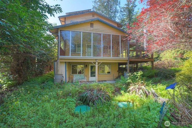 back of property with a sunroom