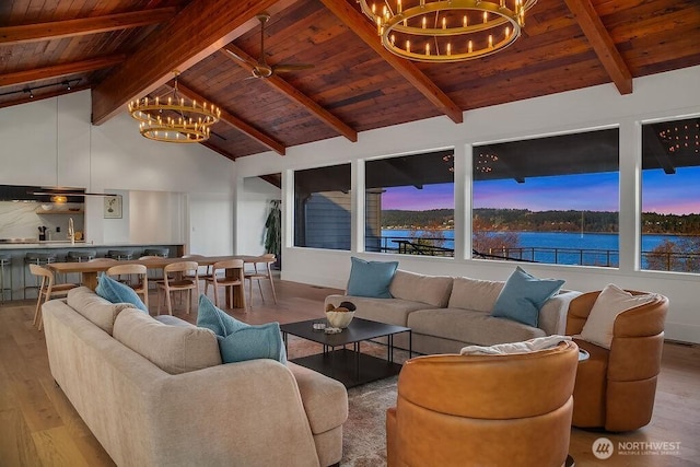 5023 Harbor Hills Dr, Freeland, WA 98249 - living room featuring beamed ceiling, wooden ceiling, wood finished floors, and an inviting chandelier