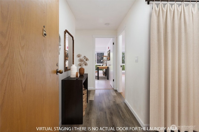 hallway with baseboards and wood finished floors