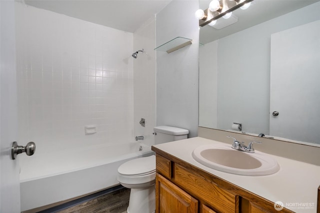 full bath featuring tub / shower combination, wood finished floors, toilet, and vanity
