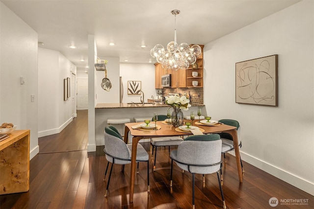605 5th St Unit B302, Kirkland, WA 98033 - dining room featuring baseboards, recessed lighting, dark wood-style floors, and an inviting chandelier