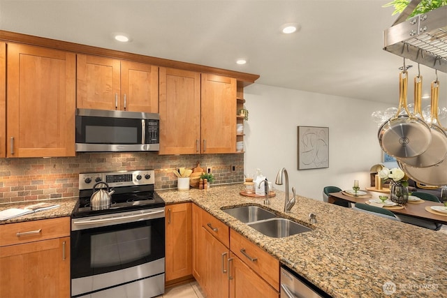 605 5th St Unit B302, Kirkland, WA 98033 - kitchen with open shelves, light stone counters, a sink, appliances with stainless steel finishes, and backsplash