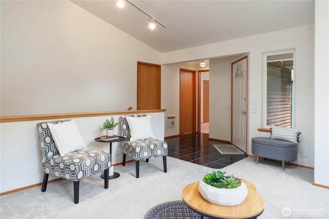 sitting room featuring rail lighting, vaulted ceiling, carpet flooring, and baseboards
