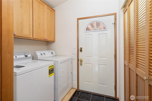 clothes washing area with washing machine and clothes dryer, dark tile patterned floors, and cabinet space