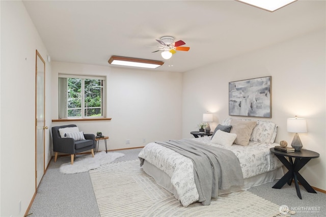 bedroom with carpet floors, a ceiling fan, and baseboards