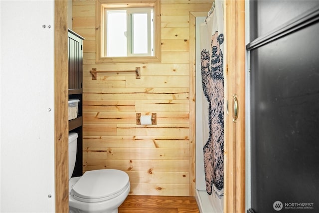 89 Eliza Is, Bellingham, WA 98226 - full bathroom featuring wooden walls, toilet, and a shower with shower curtain