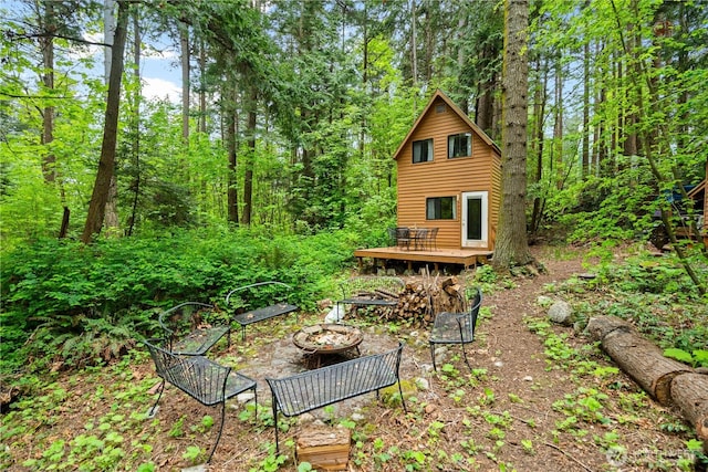 89 Eliza Is, Bellingham, WA 98226 - exterior space featuring a view of trees, a fire pit, and a deck