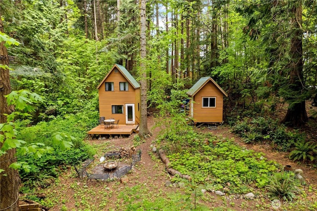 89 Eliza Is, Bellingham, WA 98226 - view of yard featuring a wooden deck, an outdoor structure, a shed, and a forest view