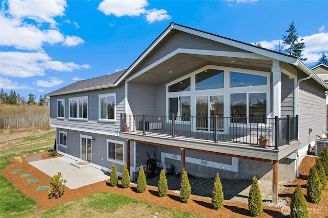 rear view of property with a patio and central AC unit