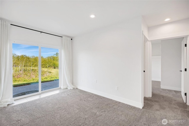empty room with carpet floors, recessed lighting, and baseboards