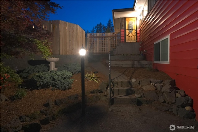 view of side of home featuring fence