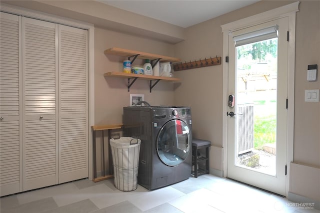 laundry area featuring laundry area, washer / dryer, and light floors