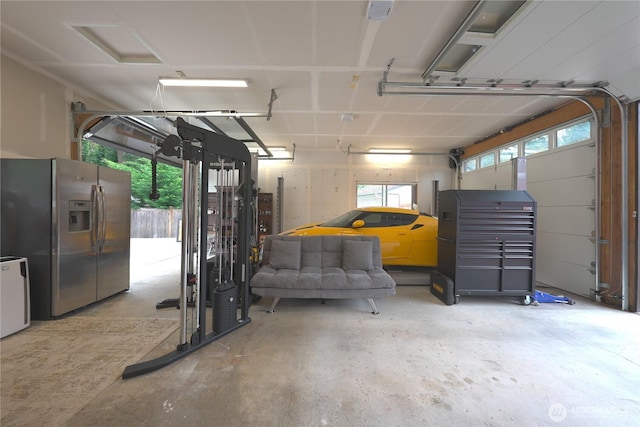garage with stainless steel fridge with ice dispenser