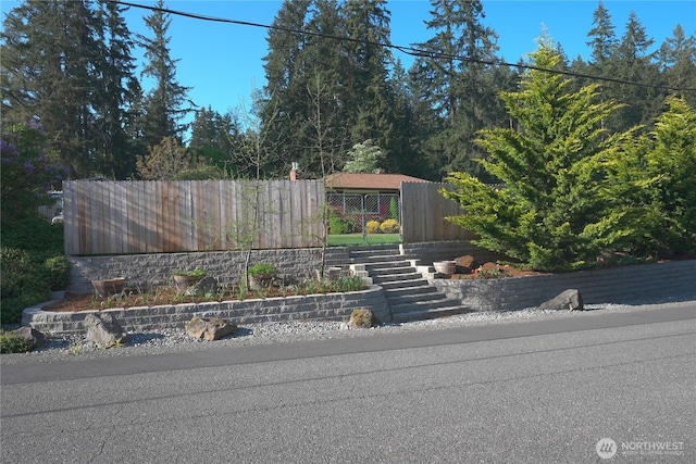 view of front facade featuring stairs and fence