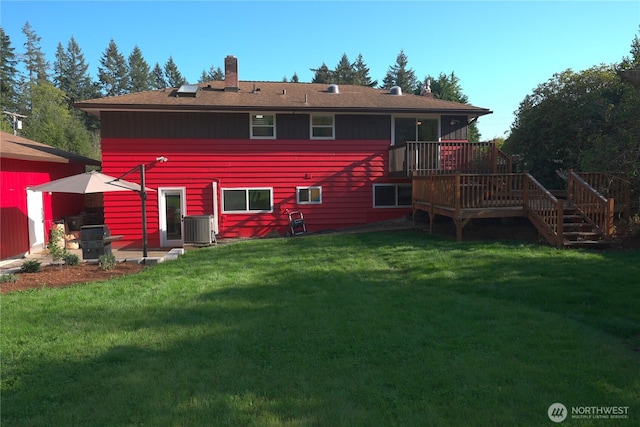 rear view of house featuring a deck, cooling unit, a chimney, stairs, and a lawn