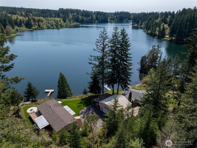 bird's eye view featuring a wooded view and a water view