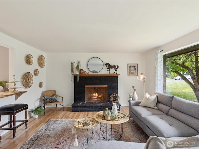 living area with wood finished floors and a fireplace
