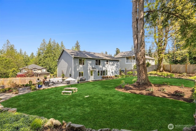 back of property with an outdoor living space, a fenced backyard, a yard, and a patio