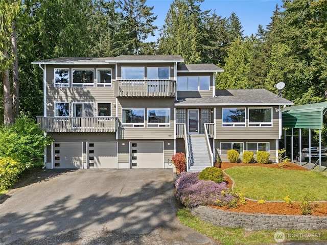 7847 SE Monte Bella Pl, Port Orchard, WA 98366 - view of front of house with asphalt driveway, a garage, stairway, a balcony, and a front yard