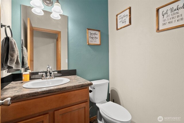 half bath with vanity and toilet