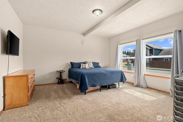 bedroom with beamed ceiling, visible vents, baseboards, and light carpet