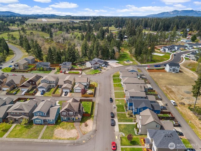 aerial view with a residential view, a wooded view, and a mountain view
