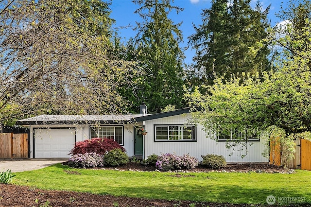 single story home featuring an attached garage, a front lawn, driveway, and fence