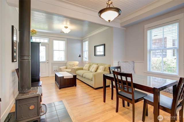 living room featuring crown molding and light wood finished floors