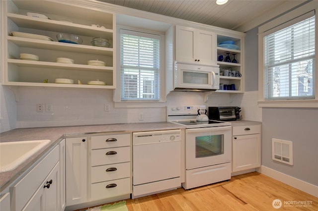 kitchen with white appliances, open shelves, light wood finished floors, light countertops, and tasteful backsplash