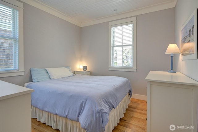bedroom with light wood-style flooring, ornamental molding, and baseboards