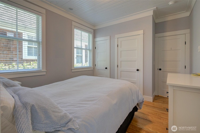 bedroom with crown molding, light wood-type flooring, multiple windows, and baseboards