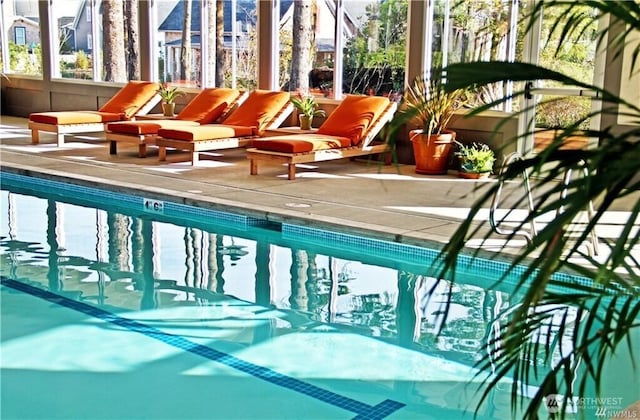indoor community pool featuring a patio area