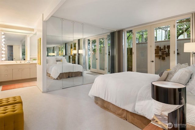 bedroom with french doors, connected bathroom, access to exterior, and radiator