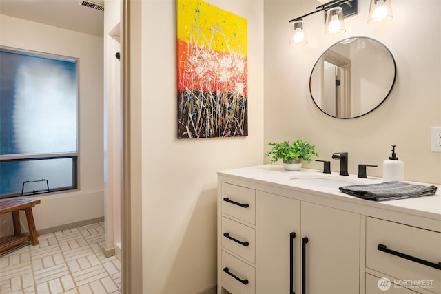 bathroom with visible vents, brick patterned floor, and vanity