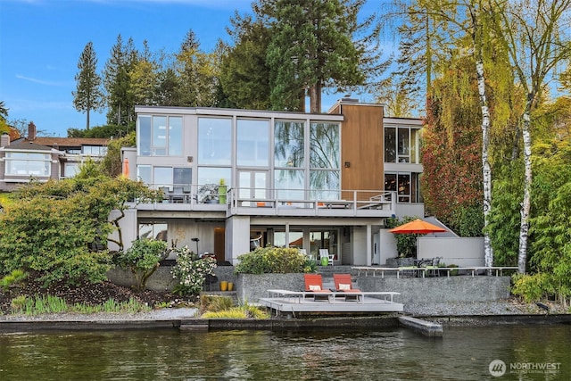 back of property with a water view