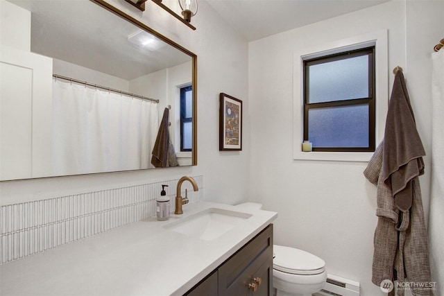 full bath with vanity, toilet, a shower with curtain, and a baseboard heating unit