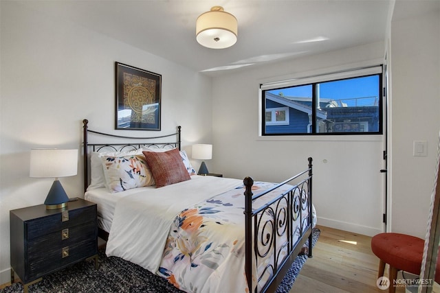 bedroom with baseboards and light wood-style floors