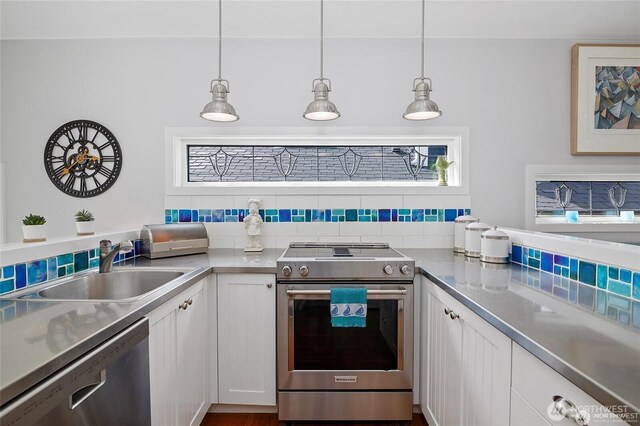 1213 E Shelby St Unit 7, Seattle, WA 98102 - kitchen with a sink, appliances with stainless steel finishes, white cabinetry, and stainless steel countertops