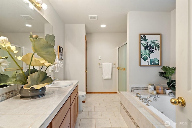 bathroom with a shower stall, a sink, a bath, double vanity, and visible vents