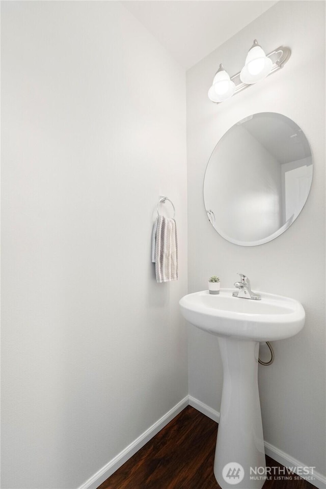bathroom featuring baseboards and wood finished floors